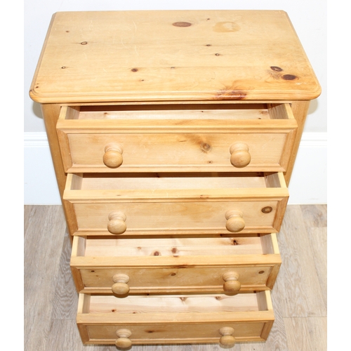 51 - A modern solid pine four drawer chest of drawers with turned handles and bun feet, approx 66cm wide ... 