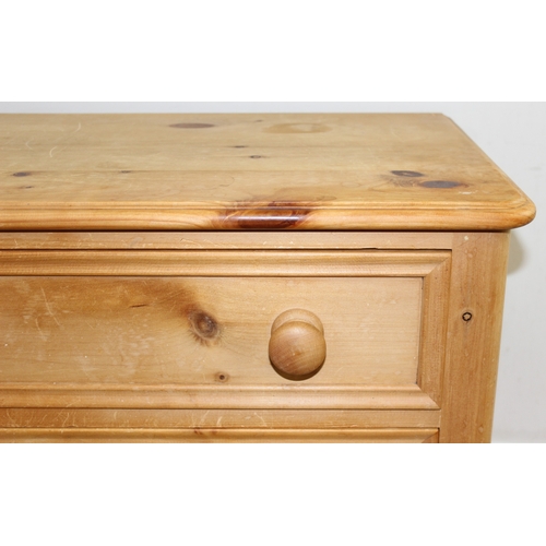 51 - A modern solid pine four drawer chest of drawers with turned handles and bun feet, approx 66cm wide ... 