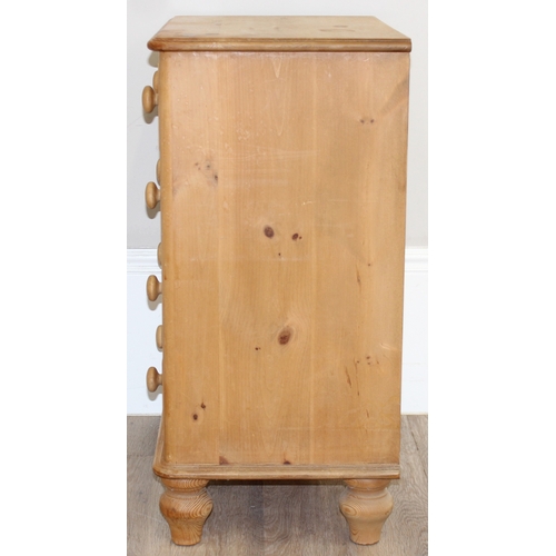 51 - A modern solid pine four drawer chest of drawers with turned handles and bun feet, approx 66cm wide ... 