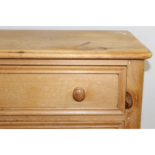 50 - A modern solid pine four drawer chest of drawers with turned handles and bun feet, approx 66cm wide ... 