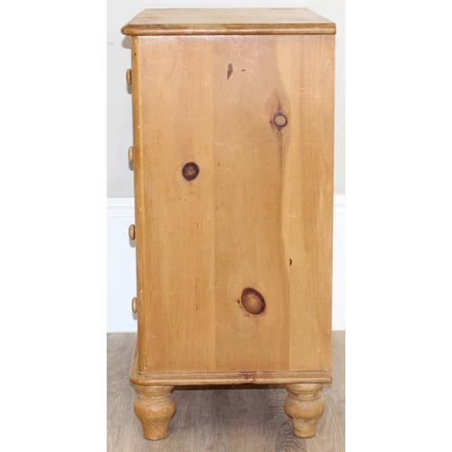 50 - A modern solid pine four drawer chest of drawers with turned handles and bun feet, approx 66cm wide ... 