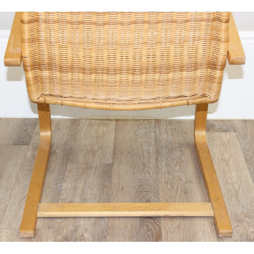 83 - A Scandinavian designed wicker chair with bentwood cantilever base, approx 58cm wide x 88cm tall