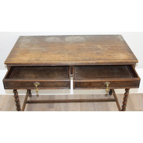 114 - An antique 17th century style oak hall table with 2 drawers and barley twist supports, approx 107cm ... 