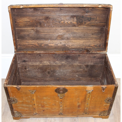 6 - An antique stained pine dome-topped chest or trunk with metal banding, approx 95cm x 49cm x 56cm