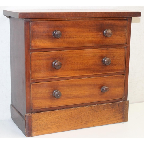 281 - A miniature 3 drawer mahogany chest of drawers with bun handles, likely an apprentice piece, c. earl... 