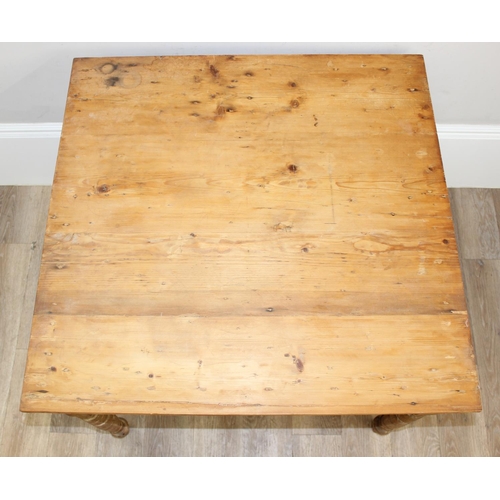 9 - A vintage pitch pine farmhouse kitchen table with turned legs, approx 90cm wide x 90cm deep x 71cm t... 