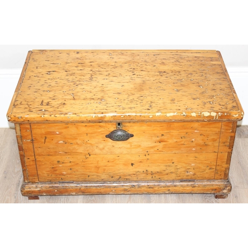 11 - An antique pine trunk with rope handles, approx 94cm wide x 56cm deep x 48cm tall