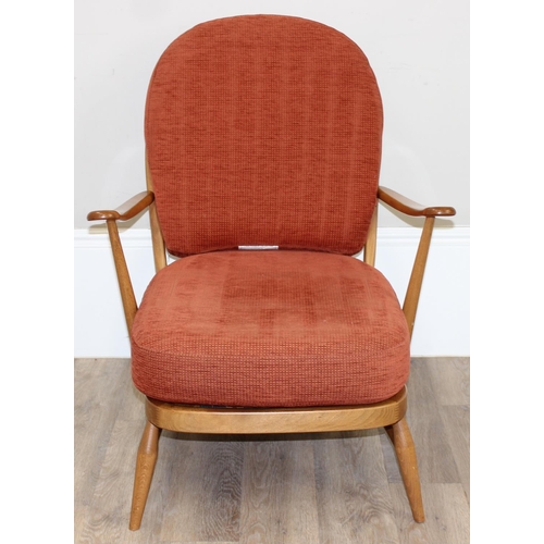 32 - A pair of Ercol low armchair with hoop backs and terracotta cushions, Golden Dawn finish, each appro... 