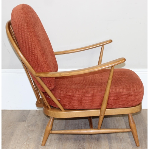 32 - A pair of Ercol low armchair with hoop backs and terracotta cushions, Golden Dawn finish, each appro... 