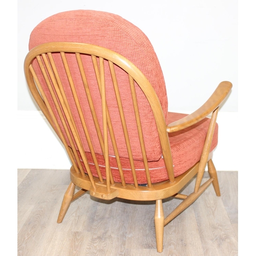 32 - A pair of Ercol low armchair with hoop backs and terracotta cushions, Golden Dawn finish, each appro... 