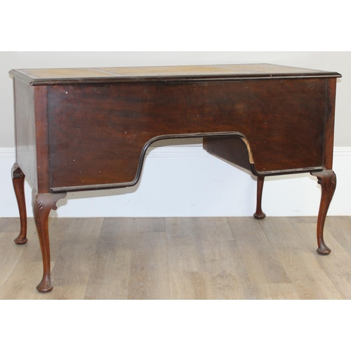 109 - An early 20th century walnut desk with cabriole legs and distressed leather top, the desk drawers wi... 