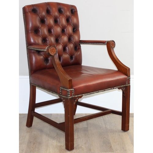 188 - A Chesterfield style dark tan-brown leather button-back armchair with exposed wooden frame, approx 9... 