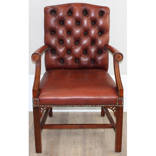 188 - A Chesterfield style dark tan-brown leather button-back armchair with exposed wooden frame, approx 9... 