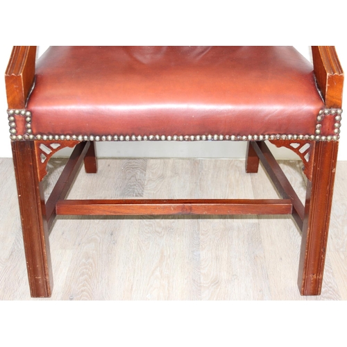 188 - A Chesterfield style dark tan-brown leather button-back armchair with exposed wooden frame, approx 9... 