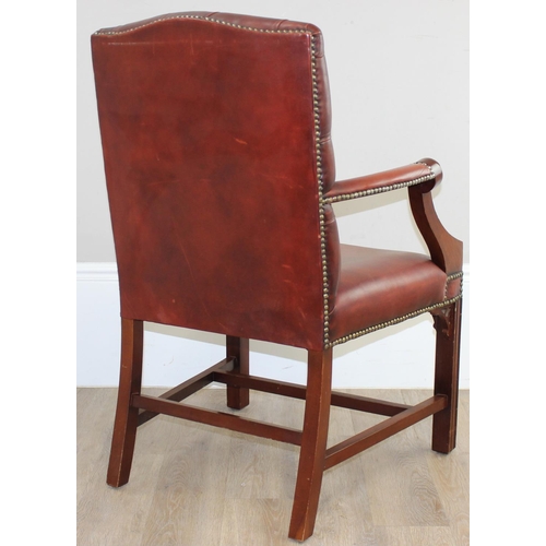 188 - A Chesterfield style dark tan-brown leather button-back armchair with exposed wooden frame, approx 9... 