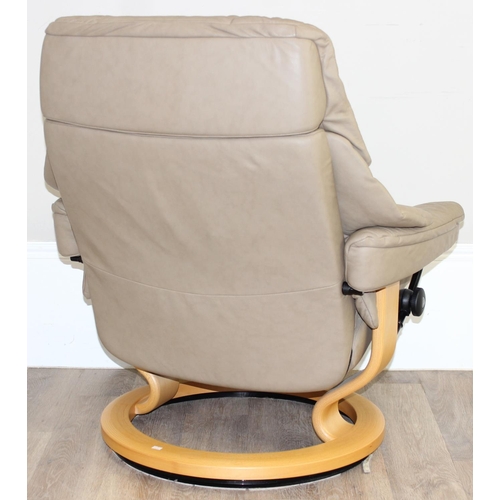 75 - A retro Ekornes of Norway Stressless reclining armchair, beige leather upholstery and wooden base, a... 