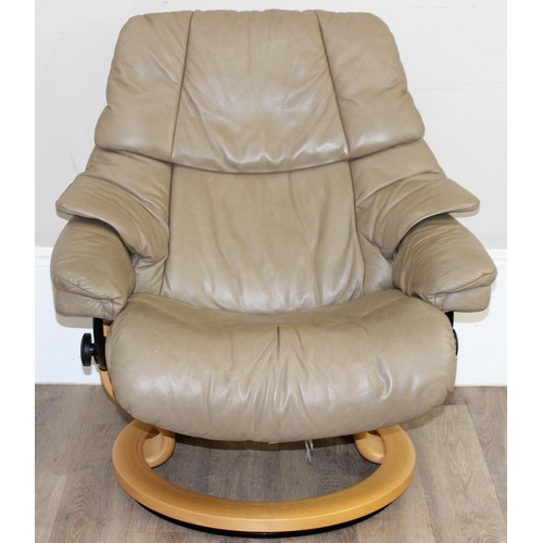 74 - A retro Ekornes of Norway Stressless reclining armchair, beige leather upholstery and wooden base, a... 