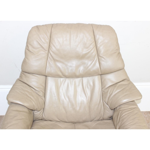 74 - A retro Ekornes of Norway Stressless reclining armchair, beige leather upholstery and wooden base, a... 