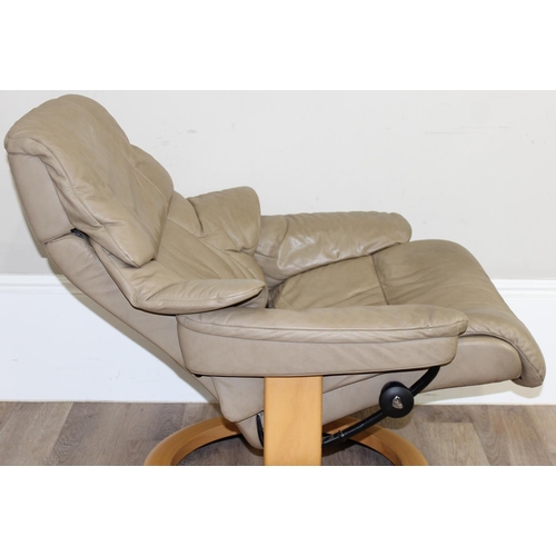 74 - A retro Ekornes of Norway Stressless reclining armchair, beige leather upholstery and wooden base, a... 