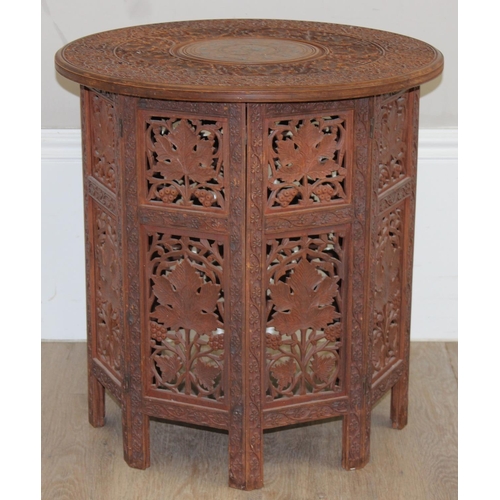 181 - An Indian carved hardwood folding table, approx 54cm x 54cm x 54cm