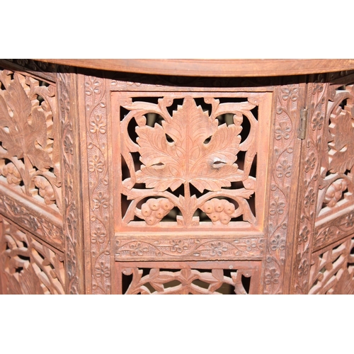 181 - An Indian carved hardwood folding table, approx 54cm x 54cm x 54cm