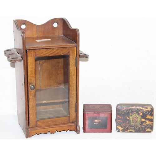 275 - An early 20th century oak pipe or smokers cabinet with glazed door and a vintage Carlysle Tobacco ti... 