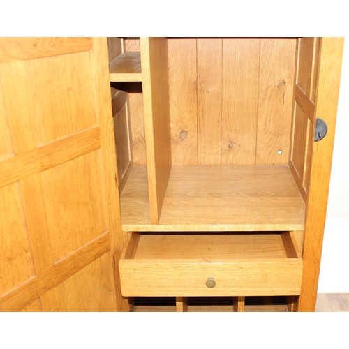 56 - In the manner of Robert 'Mouseman' Thompson of Kilburn, a superb quality panelled oak side cupboard ... 