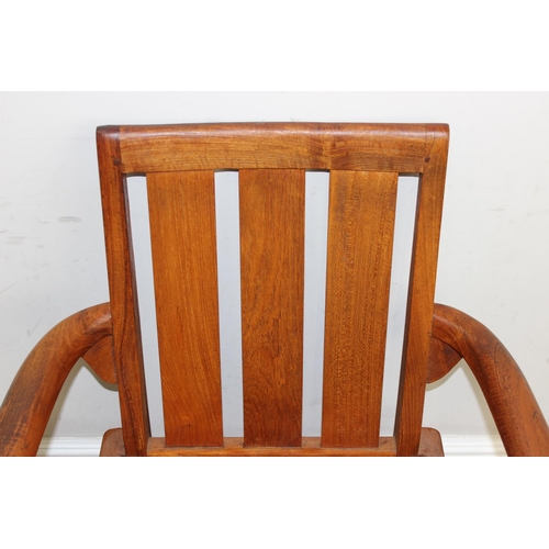 113 - A modern hardwood armchair, believed to be teak, approx 63cm W x 87cm H