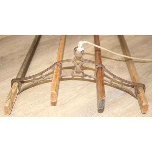 298 - A vintage wooden drying rack with cast iron fittings, approx 150cm long