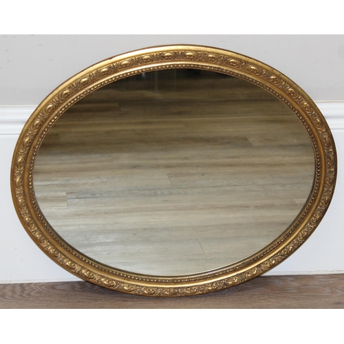 448 - A vintage oval shaped gilt framed wall mirror, approx 58cm x 48cm inc frame