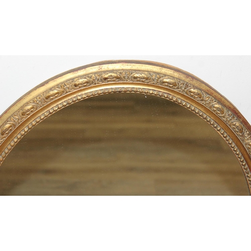 448 - A vintage oval shaped gilt framed wall mirror, approx 58cm x 48cm inc frame