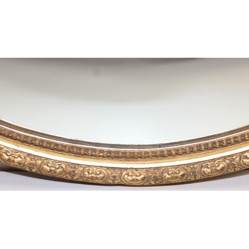 448 - A vintage oval shaped gilt framed wall mirror, approx 58cm x 48cm inc frame