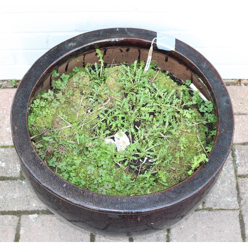 349C - Black drip glazed garden pot with contents, approx 52cm W x 25cm H