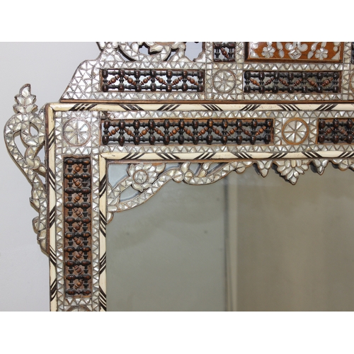 15 - Large Syrian mother of pearl inlaid wooden mirror, the intricately carved wood is inlaid with geomet... 