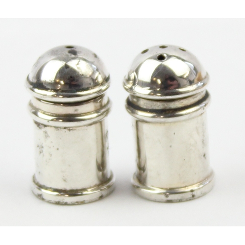 1009 - A boxed pair of miniature silver pepper pots, marked 925 and XRF confirmed, each approx 30mm tall