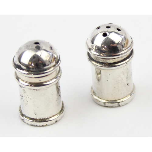 1009 - A boxed pair of miniature silver pepper pots, marked 925 and XRF confirmed, each approx 30mm tall