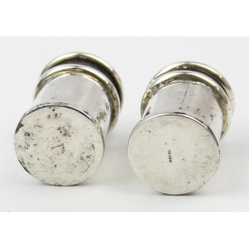 1009 - A boxed pair of miniature silver pepper pots, marked 925 and XRF confirmed, each approx 30mm tall