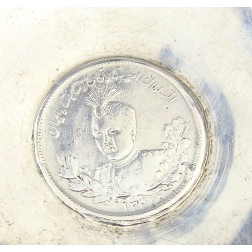 1099F - [55.87g] - an unmarked low grade silver dish set with an Iranian 5000 dinars silver coin, the dish X... 