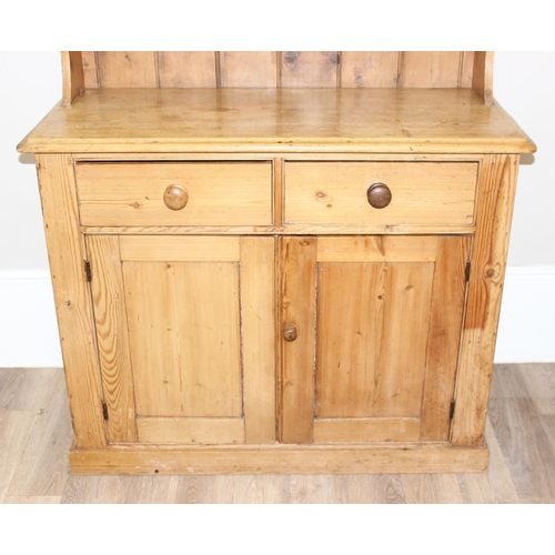 10 - A 19th century pine dresser with plate rack, 2 drawers over a cupboard, approx 109cm wide x 52cm dee... 