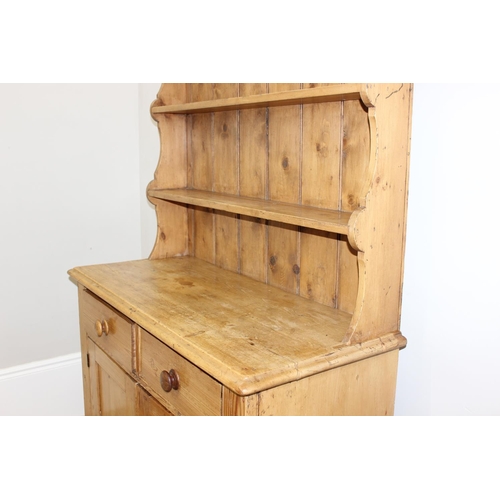 10 - A 19th century pine dresser with plate rack, 2 drawers over a cupboard, approx 109cm wide x 52cm dee... 