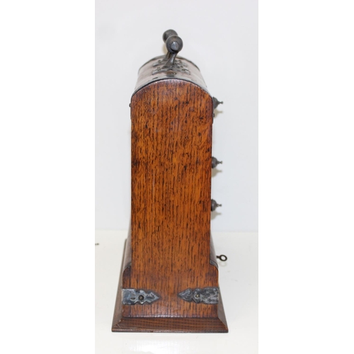 299A - A vintage oak tantalus of unusual form with single bottle and 3 drawers, the decanter a replacement,... 