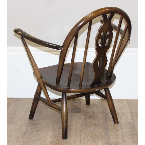 48 - An Ercol fleur-de-lys armchair, a retro magazine rack and an antique rosewood jewellery box, the cha... 