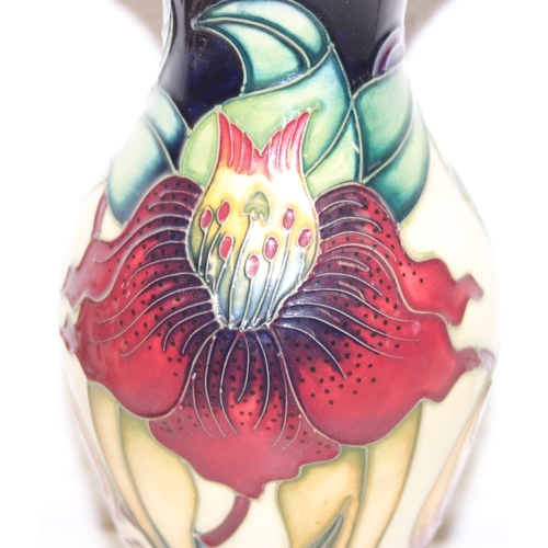 1458 - A Moorcroft pottery vase of baluster form, Anna Lily pattern, late 20th century, marks to base, and ... 