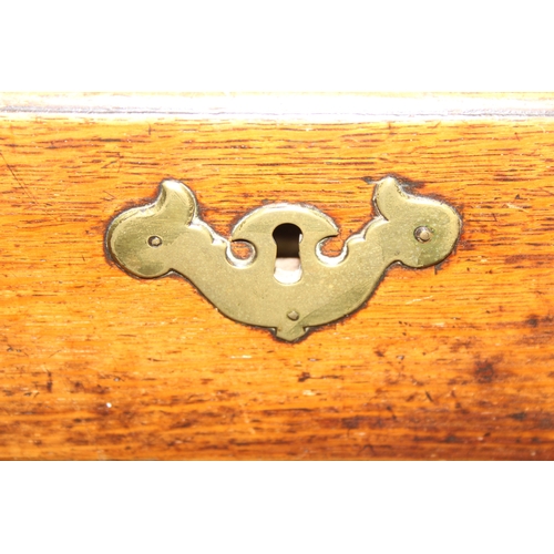 38 - A Georgian oak kneehole desk, one long drawer over six short drawers with cupboard, brass fittings a... 