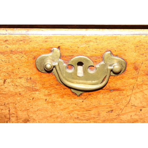38 - A Georgian oak kneehole desk, one long drawer over six short drawers with cupboard, brass fittings a... 
