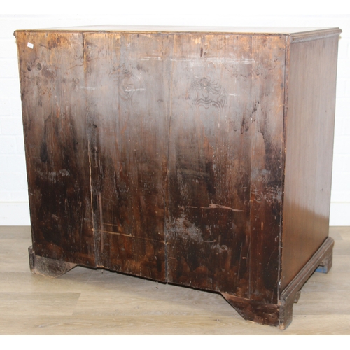 38 - A Georgian oak kneehole desk, one long drawer over six short drawers with cupboard, brass fittings a... 