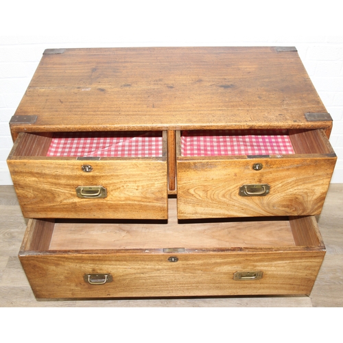 33 - An antique camphorwood two over one chest of drawers with recessed brass campaign handles and bracke... 