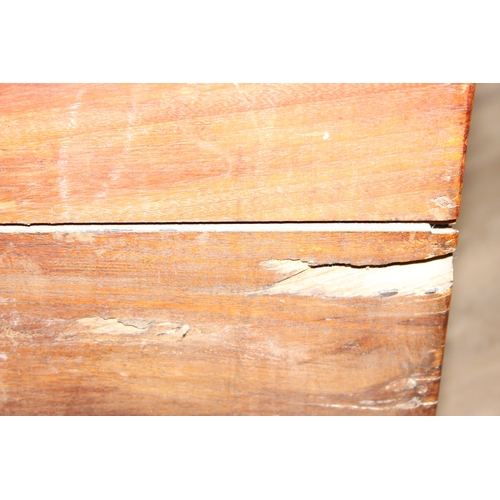 33 - An antique camphorwood two over one chest of drawers with recessed brass campaign handles and bracke... 