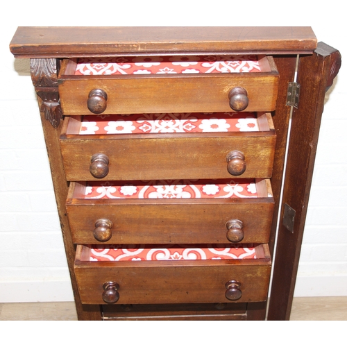 4 - An antique mahogany Wellington chest, seven drawers with turned handles and carved details to pillar... 