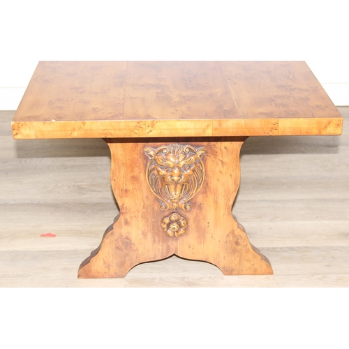 199C - A superb quality modern coffee table with yew wood finish, lion mask adornments to legs, 143cm x 69c... 